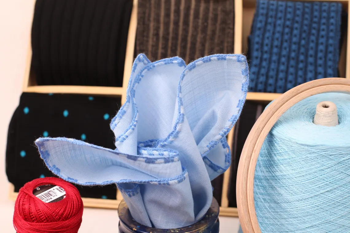 Wedding accessory gift idea – linen blue pocket square with rolled edges.