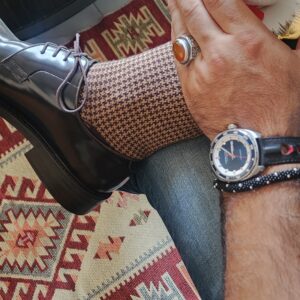 Men's brown and beige merino wool houndstooth socks styled with leather dress shoes